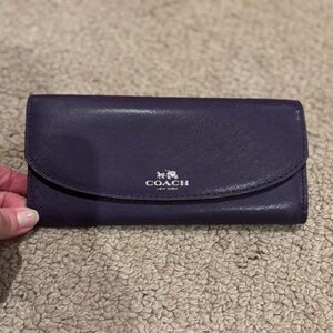 Coach slim envelope wallet in purple. Snap closure.